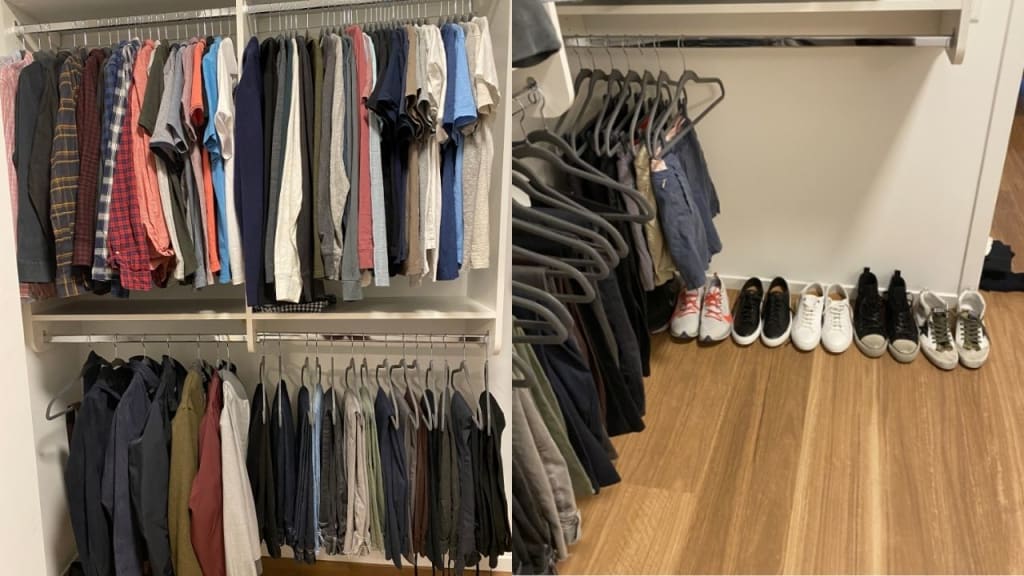A neatly organized closet with shirts and jackets hanging on racks and a row of shoes lined up on the wooden floor.